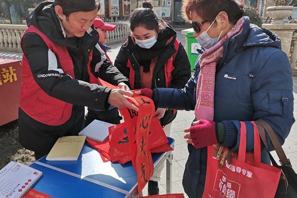 教师志愿者向居民赠送春联.jpg